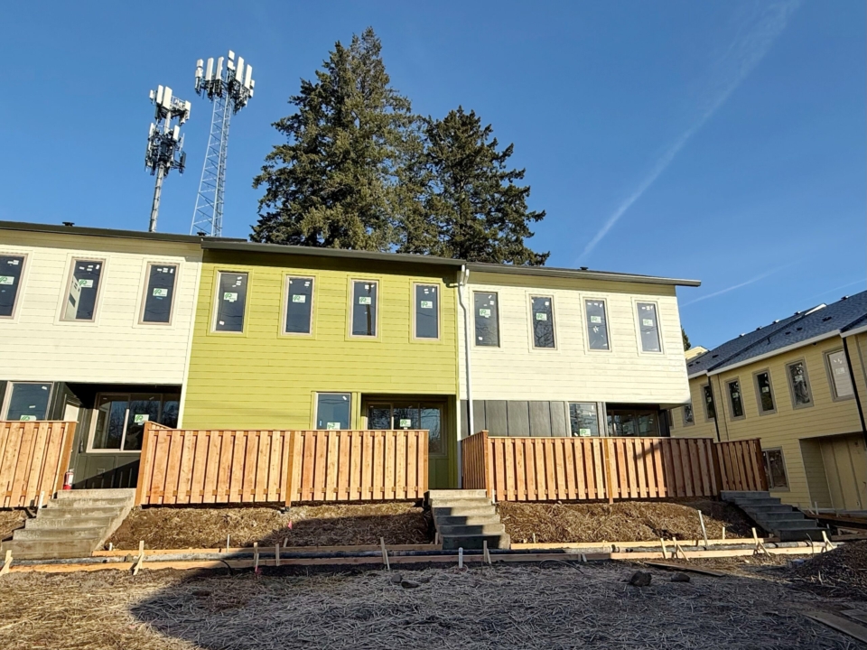 Building 2 of King City Commons, painted green and white