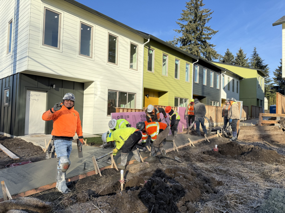 Crews pour cement for sidewalks at King City Commons