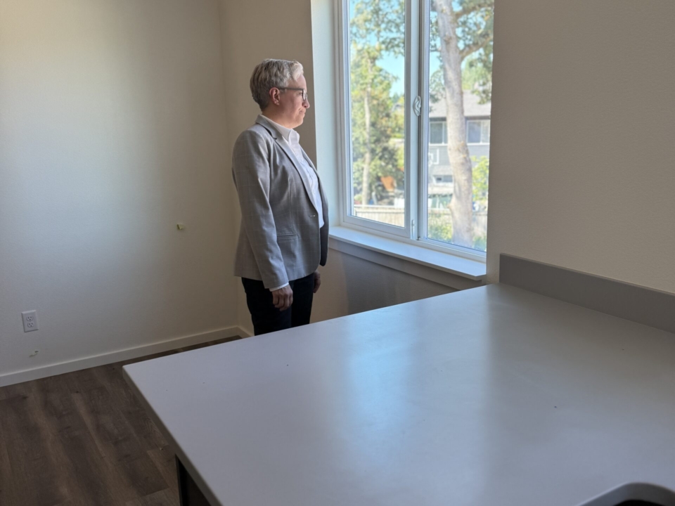 Oregon Gov. Kotek looks out the window of Habitat home