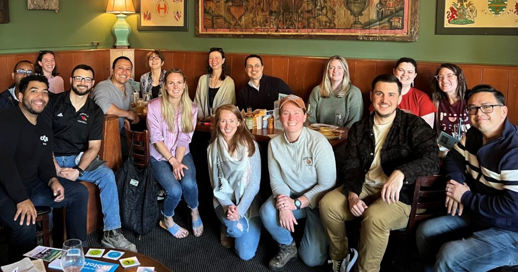 Ambassador Council members smiling at happy hour meeting