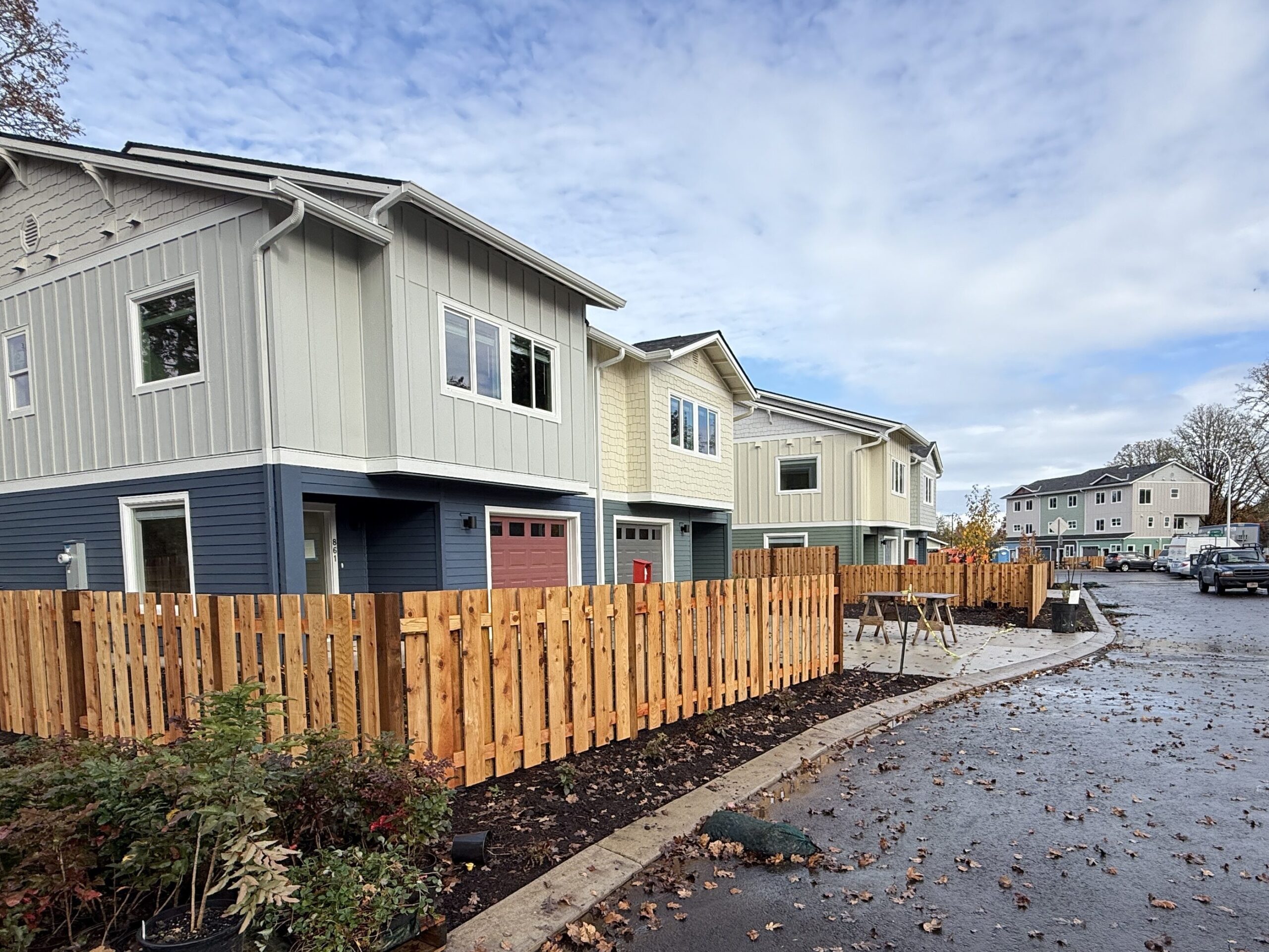 The same two homes as pictured left are fully finished: complete with paint, trim, fences, and landscaping.