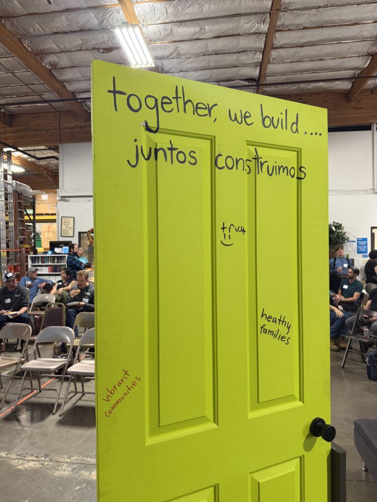 A bright green door reads "together, we build... juntos construimos."